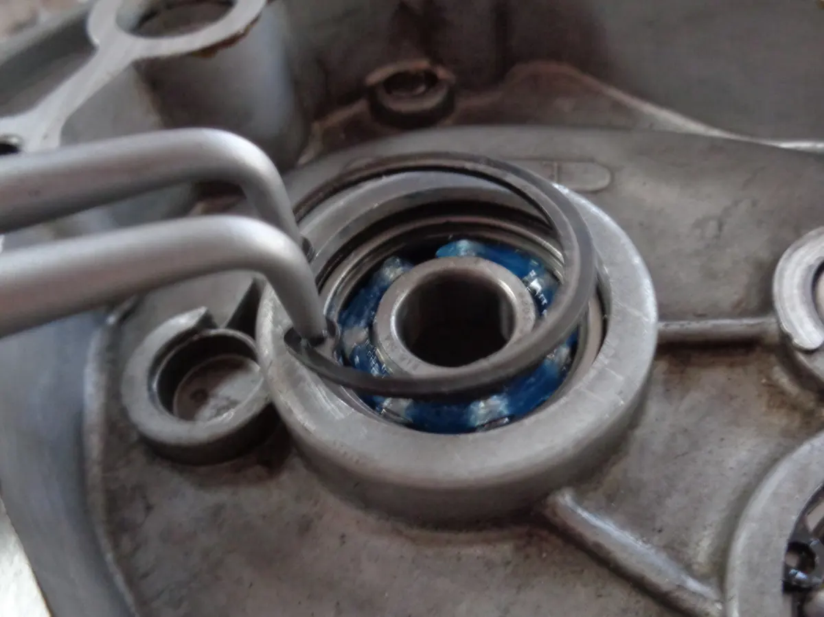 Freno Seeger siendo montado en el alojamiento de la reductora de un vespino para evitar que el rodamiento del eje del piñón de bici se mueva de su poscición