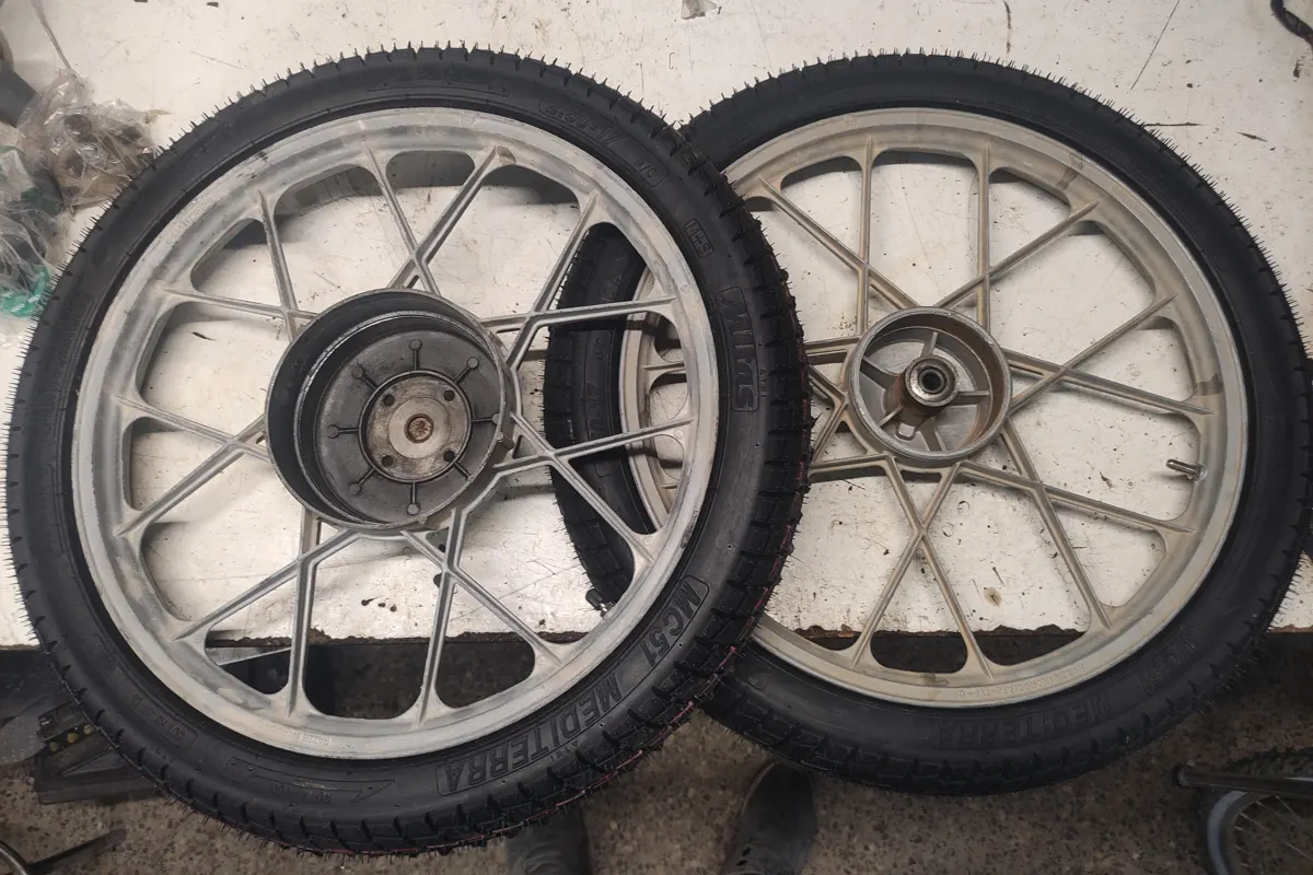 Llantas de vespino con sus ruedas nuevas sobre una mesa para montarlas en su destino